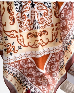 Close-up of silk scarf featuring bohemian paisley patterns and earthy tones texture