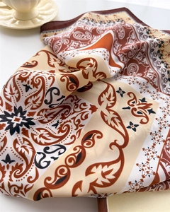 Detail of elegant paisley print silk scarf with vintage bohemian pattern on white background
