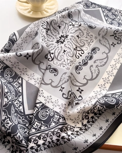 Detailed paisley print silk scarf with classic grey patterns and subtle text accents