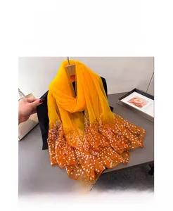 Detail of yellow gradient floral long scarf with white flowers on a black mannequin