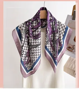 Detail of silk square scarf featuring elegant equestrian prints with purple and blue borders