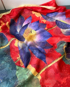 Detail of red silk scarf with blue lotus print and subtle square texture weave