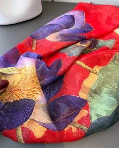 Close-up of red silk scarf with painted purple lotus and green lily pad pattern