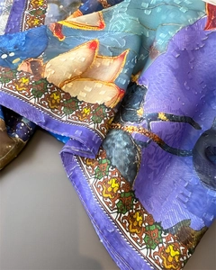 Close-up of silk scarf with magnolia prints, jacquard texture and baroque borders