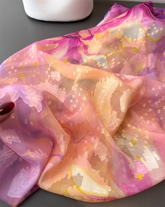 Detailed close-up of colorful magnolia floral chiffon scarf with elegant jacquard texture