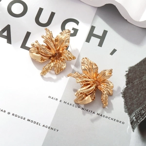 Elegant vintage gold lily flower earrings with textured 3D petals and metallic luster