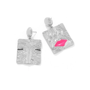 Close-up of square silver alloy earrings with pink lip detail and ethnic textures
