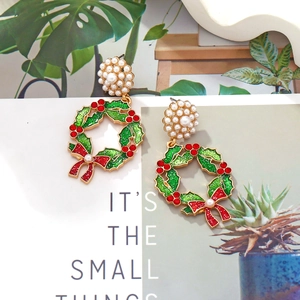 Christmas wreath earrings with pearls, red bows, and green sequins on festive gold alloy