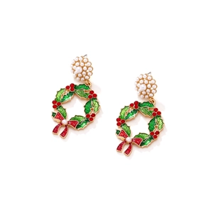 Christmas wreath earrings with pearls, colorful crystals, and red bows on white background