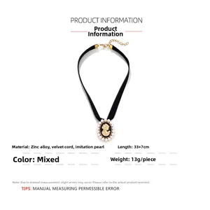 Detail of vintage black velvet choker with gold cameo pendant and white faux pearls