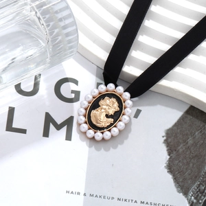 French vintage velvet choker with a gold cameo portrait pendant and pearl accents