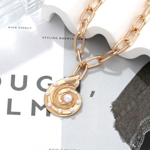 Gold conch shell pendant necklace with white pearls and chunky oval link chain for women
