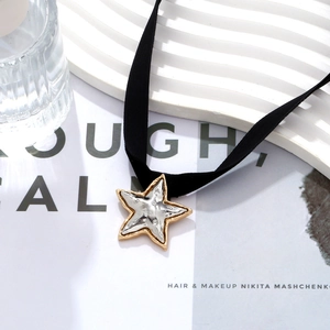 French vintage two-tone star pendant on black velvet choker with hammered metal texture