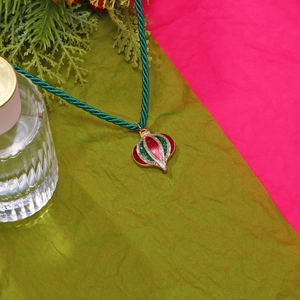 Christmas pendant necklace with red and green enamel on a dark green twisted cord