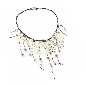 Handcrafted layered white floral necklace with elegant tassel drop and beaded details