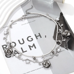 Layered faux pearl and silver rose vine necklace with intricate flower details and beads