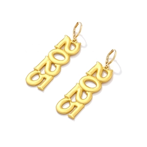 Golden 2021 drop earrings with metallic finish for women on a minimalist white background