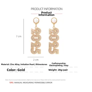 Detail view of 2025 rhinestone earrings with dimensions 7cm by 2cm in gold finish