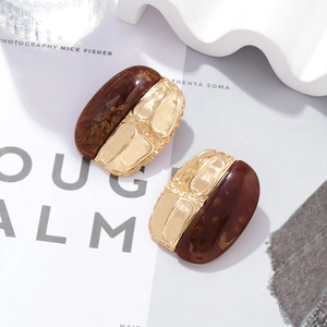 Retro geometric earrings with brown amber resin and gold textured metal design