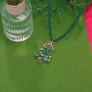 Glitter green Christmas tree necklace with pink bow on green woven cord for festive wear