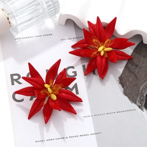 Close-up of red multilayer beaded floral earrings with yellow center and petal details
