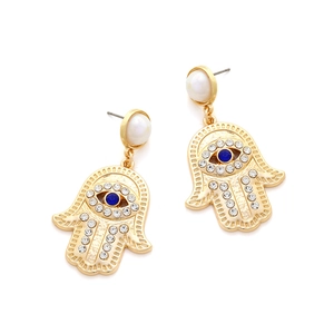 Detail of Hamsa Hand earrings with blue eye stone and white crystals on gold alloy