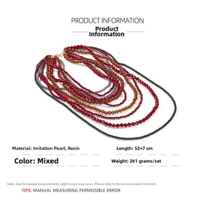 Close-up of bohemian layered beaded necklace featuring red and brown resin beads