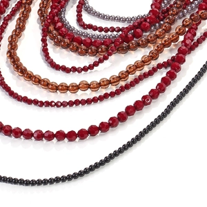 Detail of layered beaded necklace featuring gradient resin stones and faceted glass beads