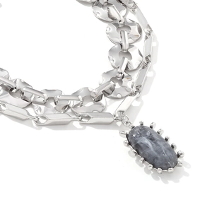 Detail of multi-layer silver chain necklace featuring a grey marble stone pendant