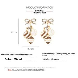 Detail of Christmas bow earrings with colorful enamel balls and dimensions 5.5x3.3cm