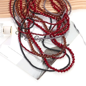 Multilayer beaded necklace with gradient red, amber, and black beads in waterfall design