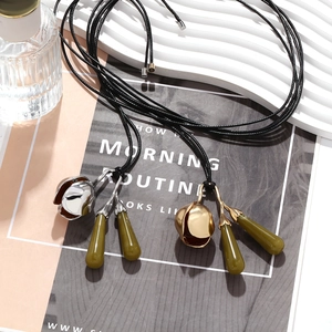 Vintage floral pendant necklace with resin olive green drops on adjustable black cord