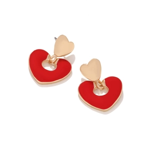 Detail of red enamel heart-shaped drop earrings with golden metal hollow design