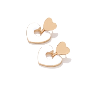 Detail of gold double heart earrings with white enamel drop design on white background