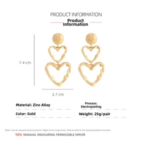 Detail view of layered gold heart drop earrings with 7.4x3.7cm size specifications