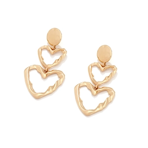 Detailed close-up of golden multi-layered heart earrings with unique hammered metal texture