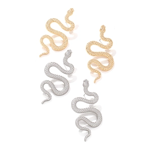 Vintage gold and silver serpent drop earrings with hammered texture on white background