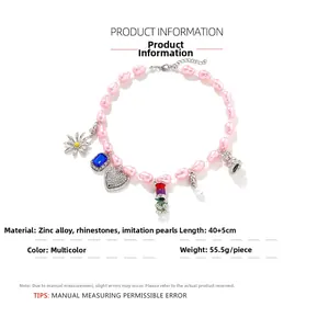 Detailed view of pink beaded necklace with charms including daisy, heart, and crystal charms