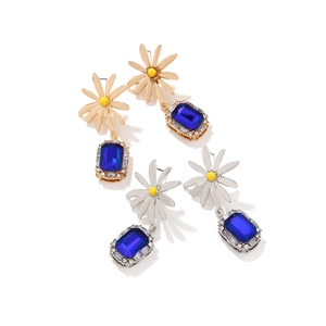 Elegant daisy flower earrings with large blue rectangular gemstones and rhinestone details