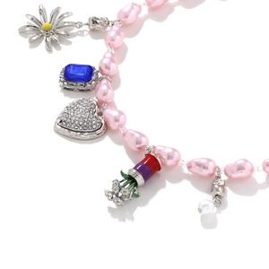 Pink baroque pearl necklace with heart, daisy, and blue gemstone charms for women