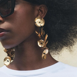 Exaggerated long handmade floral earrings with textured gold hammered metal finish