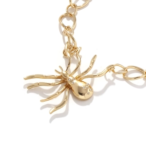 Bold golden spider pendant necklace with rhinestone accents and thick chunky metal chain