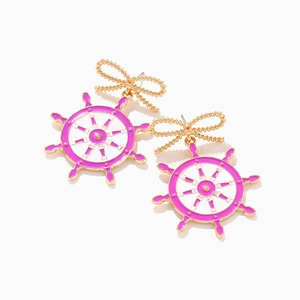 Detailed view of gold alloy bowknot earrings with pink and white enamel nautical helm charms