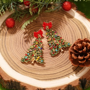 Christmas tree earrings with green enamel and rhinestones on natural wood