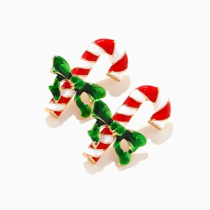Festive Christmas candy cane earrings with red white enamel and dark green bow decoration