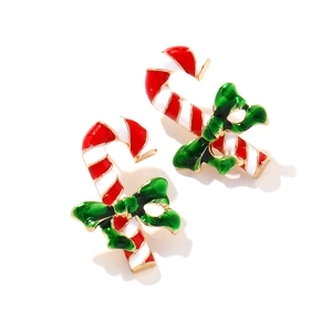 Christmas candy cane earrings with red white stripes and a green bow on white background