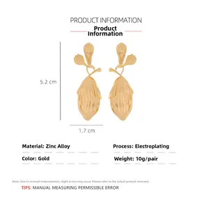 Macro view of gold leaf drop earrings with 3D texture and size dimensions 5.2cm x 1.7cm