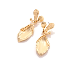 Macro detail of golden alloy leaf earrings featuring organic 3D textures and metallic finish