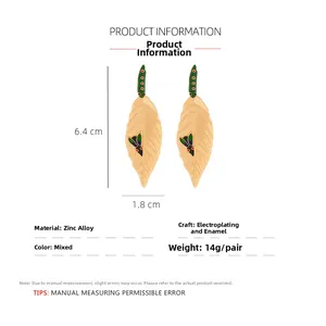 Detailed view of enamel leaf drop earrings with insect motifs and gold plating