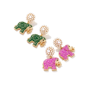 Detail of colorful elephant earrings with enamel patterns and imitation pearls